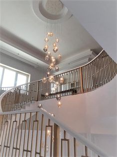 a spiral staircase with chandelier hanging from the ceiling