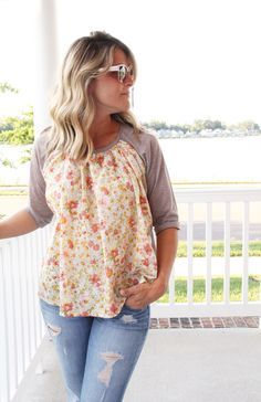 a woman standing on a porch with her hands in her pockets