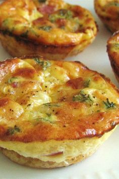 several small quiche pies on a white plate