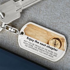 a keychain with a compass on it that says, enjoy the next charter