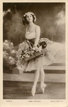 an old black and white photo of a woman in a tutu with flowers on her head