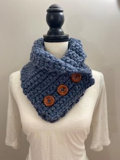 Lovely navy heather!  Warm and stylish!  This three button scarf is double crocheted (using two strands of yarn) for warmth.  The buttons are made of wood and are stained in a black finish and measure 1 1/4" in diameter.  The scarf measures 32" in length and 8" in width.   The scarf can be unbuttoned and adjusted accordingly.  Please message me if you would like to see other button choices.  100% Acrylic Yarn Machine wash on delicate.  Do not use bleach.  Machine dry on low heat.  Do not iron. Made Of Wood, Double Crochet, Acrylic Yarn, Scarf Wrap, Heathers, Scarf Accessory, Bleach, Heat