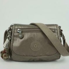 Color: Metallic Pewter 8"L X 6.7"H X 3" D Flap Closure With Magnetic Snap Front Slip Pocket Adjustable Strap Internal Zip Pocket Monkey Keychain Cross Body Bags Women Casual, Medium Size Bags Handbags, Kipling Shoulder Bag, Kipling Purse, Monkey Keychain, My Style Bags, Beaded Shoes, Mini Messenger Bag, Kipling Bags