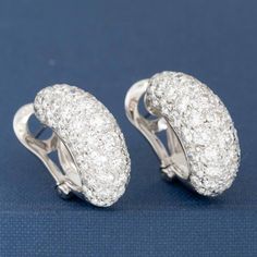 Who doesn't need huggie earrings studded with over 7cts of diamonds? I'm certainly raising my hand! This pair is both sexy and elegant at the same time, and sits on the lobes beautifully. A wonderful addition to any jewelry wardrobe, going beautifully from day to night. 18kt white gold Diamonds are estimated to be G/H colors & VS/SI1 clarities. GIA Standards Please see qualtiative report for more information. Luxury Hand Set Round Diamond Earrings, Luxury Pave Set Hoop Earrings For Wedding, Luxury Hoop Earrings With Pave Setting For Wedding, Luxury White Gold Diamond Hoop Earrings, Luxury Wedding Hoop Earrings With Pave Setting, Luxury Diamond Huggie Earrings In Diamond White, Luxury Pave Setting White Gold Huggie Earrings, Luxury Diamond White Diamond Huggie Earrings, Luxury Diamond White Brilliant Cut Huggie Earrings