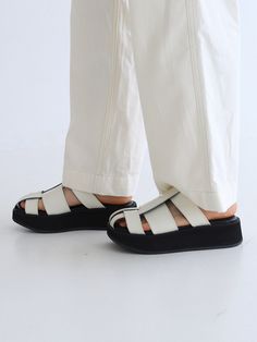 Editor's NotesThese sandals feature simple design and light weight. It is good to wear for various activities. - Unique strap- Summer shoes- Daily item- Goes well with any casual looksMeasurements(in.)- Size: KR 225MM(US 5.5) ~ KR 255MM(US 8.5)- Heel Height: 1.57 in.*Fits true to size.Composition & Care- Upper: Cowhide- Sole: Rubber- Please check the care labelDesigner- by MOL:pin Modern White Sandals With Rubber Sole, Modern White Open Toe Sport Sandals, Modern White Leather Footbed Sandals, Modern White Sandals With Leather Footbed, Modern Open Toe Sport Sandals, Modern White Open Toe Footbed Sandals, Modern White Platform Sport Sandals, Modern White Closed Toe Sandals, Modern White Sport Sandals With Round Toe