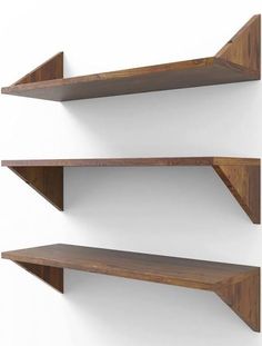 two wooden shelves on the wall with white walls