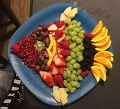 a blue plate topped with lots of fruit