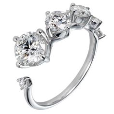 an engagement ring with three stones in the middle and two diamonds on each side,