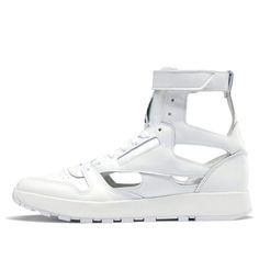 Looking for a hybrid sneaker that blends retro style with modern attitude? Check out the Reebok Maison Margiela x Classic Leather Tabi High in white. This unique sneaker is based on an early 80s runner, with a few twist courtesy of fashion house Maison Margiela. The result is a fresh take on a classic silhouette that's sure to turn heads. The Maison Margiela x Reebok Classic Leather Tabi High features Margiela's signature décortiqué technique, resulting in an open white leather build that's insp Modern Streetwear Sneakers With Vented Sides, Modern Vented Sides Sneakers For Streetwear, White High-top Sneakers With Vented Sides For Streetwear, Modern High-top Sneakers With Perforated Toe Box For Streetwear, Low-top Custom Sneakers With Vented Sides For Streetwear, Custom Low-top Sneakers With Vented Sides For Streetwear, Modern Custom Sneakers With Perforations For Streetwear, Streetwear Low-top Custom Sneakers With Vented Sides, Sporty High-top Sneakers With Vented Sides