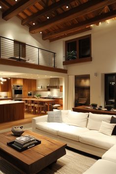 a living room filled with furniture next to a kitchen