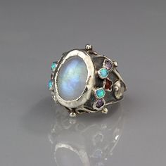 Silver moonstone queen ring Unique White Multi-stone Moonstone Ring, Celestial Multi-stone Oval Moonstone Ring, Celestial Multi-stone Moonstone Oval Ring, Celestial Multi-stone Moonstone Ring, Unique Opal Ring With Moonstone, Moonstone Multi-stone Opal Ring As Gift, Multi-stone Moonstone Opal Ring For Gifts, Unique Open Moonstone Ring, Unique Moonstone Rings With Gemstone Accents