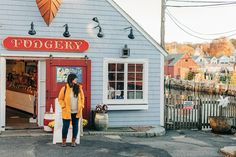 a woman standing in front of a small store