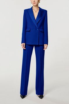 a woman wearing a blue suit and black shoes