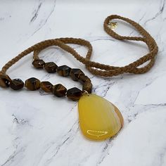 Brand New French Connection Necklace. Semiprecious Gorgeousness! A Total Of 12 Tiger Eye Beads With A Yellow Agate Pendant. Total Length Of The Tan, Braided Suede Necklace Is 36”. The Agate Pendant Is 2 1/4” In Length And Width Is 1.5”. No Clasp. Natural Beauty. Ships Quickly And From A Smoke Free Environment. Yellow Spiritual Beaded Necklace With Gemstone Beads, Yellow Gemstone Beaded Necklaces With Round Beads, Yellow Agate Jewelry With Natural Stones, Yellow Faceted Beads Jewelry For Beach, Handmade Yellow Citrine Necklaces, Yellow Gemstone Beaded Necklaces As Gift, Yellow Gemstone Beaded Necklaces For Gifts, Yellow Gemstone Beaded Necklace For Gifts, Yellow Necklaces With Faceted Beads