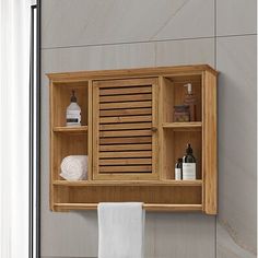 a wooden shelf with towels and soaps on it