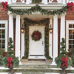 a house decorated for christmas with wreaths and decorations