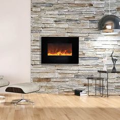 a living room with a stone wall and a fire place in the fireplace that is lit