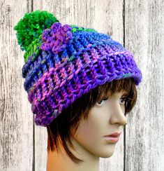 a mannequin head wearing a multicolored knitted hat