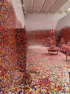 a room filled with lots of different colored confetti on the walls and floor