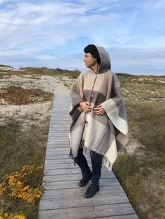 EXTRA QUALITY NATURAL WOOL CAPE WITH A HOOD Size: 130x190 cm (51x75 In) Colour: Brown Materials: 100% pure natural New Zealand wool. Made: in Lithuania. Cape with a hood is a great choice for a windy and cool day. A warm cape with a hood - an indispensable clothing for those resting by the sea, with which no harsh seaside winds will be dreadful.    The soft, smooth capes from 100% natural New Zealand wool fabric designed specifically for capes. ( Blankets are made from this natural wool yarn too Cozy Wool Poncho Cape, Beige Hooded Poncho For Fall, Cozy Brown Wool Poncho, Beige Alpaca Poncho For Winter, Winter Beige Alpaca Poncho, One Size Beige Wool Poncho, Beige Wool Poncho One Size, Cozy Beige Wool Poncho, Hooded Wool Poncho For Fall