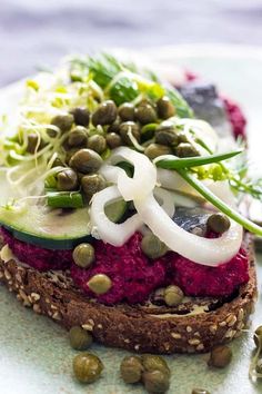 a sandwich with vegetables and seeds on it