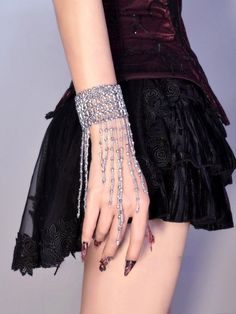 Enhance your cyberpunk look with our stunning cyberpunk silver gothic tassels beads stretch bracelet. This edgy and versatile bracelet features intricate tassels and beads, adding a touch of gothic flair to any outfit. Whether you're attending a music festival or a night out with friends, this stretch bracelet is the perfect accessory to make a bold fashion statement.  Please note that this product includes only one bracelet.  Garment Size   	 		 			Size 			Free Size 		 		 			Adjustable Circumfe Edgy Silver Beaded Jewelry, Silver Beaded Body Jewelry For Party, Silver Beaded Metal Body Jewelry, Adjustable Punk Body Jewelry For Party, Edgy Silver Body Jewelry For Festivals, Party Beaded Metal Body Jewelry, Edgy Adjustable Body Jewelry For Parties, Adjustable Edgy Body Jewelry For Parties, Edgy Metal Bracelets For Parties