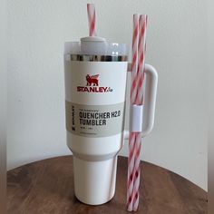 a cup with two straws in it sitting on a table