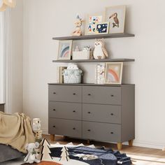 a child's room with toys and decor on the wall, including a dresser