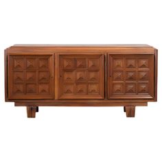 a wooden sideboard with many drawers and doors on the front, against a white background