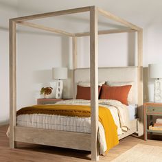 a bedroom with a four poster bed and nightstands