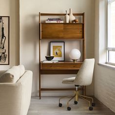 a living room with a couch, chair and desk