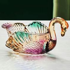 a glass swan bowl sitting on top of a table