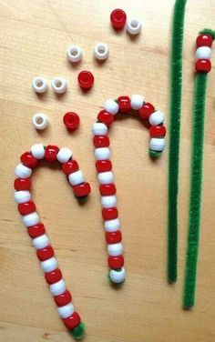 some candy canes are sitting on a table with other items to make it look like they have been made into christmas decorations