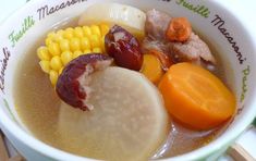 a bowl filled with meat and vegetables on top of a table