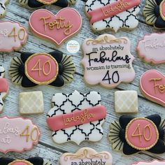 decorated cookies are arranged in the shape of hearts and numbers for women's birthdays