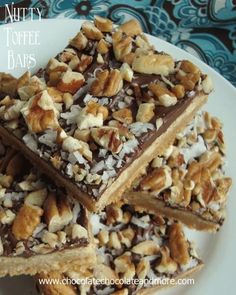 nutty toffee bars stacked on top of each other with chocolate and nuts