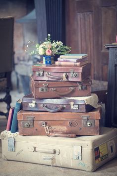 a stack of suitcases sitting on top of each other in front of a fireplace