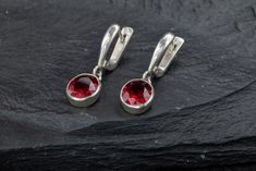 Oval Ruby Earrings set with a Created Ruby in a flawless diamond cut & clarity, deep red color, at 10x8mm (6 Cts a pair).Solid 925 Sterling Silver ☞ made to last. Click here for ☞ Matching Ring Matching Pendant ☞ please ask me Details:• Created Ruby in a deep red color• Ruby: 10x8mm each, 6 Cts a pair, diamond cut• Lever Back Closure - "English Lock"• Dimensions: Length 29mm, Width 9mm• Solid 925 Sterling SilverSKU 1118 Ruby Drop Earrings, Ring Matching, Flawless Diamond, Matching Ring, Deep Red Color, Ruby Earrings, Bar Pendant, Matching Rings, Dangling Earrings