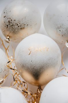 some white and gold balloons with the word happy written on them by jovo studio for stocks & bond