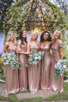 the bridesmaids are posing for a photo in their gold sequin gowns