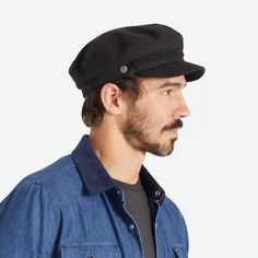 On a white background is a model wearing a black fiddler cap with a cord detail. Brixton Fiddler Cap, Fiddler Cap, Logo Pin, Pin Logo, Cap Men, The Shade, Metal Logo, Mixing Fabrics, Embroidery Details