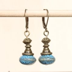 Blue Earrings Ceramic Earrings Brass Earrings Dangle Drop Earrings Boho Chic Earrings Rustic Earrings Gift for her Gift For women Color : Blue ceramic porcelain Beads ( 12mm ) Finish : Antique brass findings Size : 1,5 including the Antique Brass lever back Ear wires : Antique Brass leverback ear wire Available in green apple, Pink Rasberry and white cream: https://www.etsy.com/listing/224234693/green-earrings-ceramic-earrings-brass?ref=shop_home_active_1 https://www.etsy.com/listing/224231324/p Light Blue Metal Earrings As A Gift, Light Blue Metal Earrings For Gift, Blue Metal Drop Earrings, Light Blue Dangle Earrings For Pierced Ears, Vintage Blue Dangle Earrings, Adjustable Light Blue Earrings, Adjustable Blue Drop Earrings, Vintage Blue Beaded Drop Earrings, Adjustable Blue Teardrop Dangle Earrings