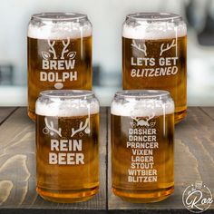 three beer glasses sitting on top of a wooden table