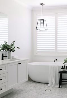 a white bath tub sitting next to a window