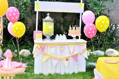 an outdoor party with balloons and decorations