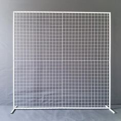 a white screen with squares on it against a gray background in front of a grey backdrop