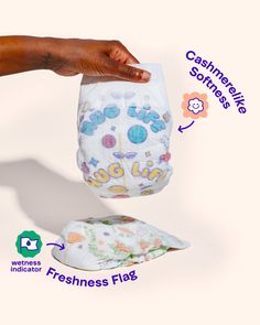 a person holding a cloth diaper in their hand with instructions on how to use it