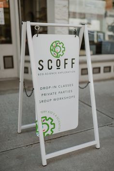 a sign on the sidewalk that says scoff drop in classes private parties group workshop