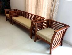 two wooden benches sitting next to each other in front of a window with curtains on it