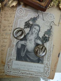 A beautiful, romantic pair of earrings... The reliquaries are early 1900's, from France.  They are celluloid imagery sealed with brass....Our Lady of Lourdes...mysteries of the Grotto.   I have suspended the reliquaries from recast brass and sterling rosary connectors. The ear wires are sterling and handwrought. The front and back of each reliquary are the same.  Should the buyer want the same image to the front, let me know and I will make the change. Length:  2.5 inches Weight:  light So beaut Vintage Miraculous Medal Jewelry, Vintage Miraculous Medal Pendant Jewelry, Our Lady Of Fatima Necklace Vintage, Vintage Sterling Silver Miraculous Medal, Spiritual Jewelry: Our Lady Of Guadalupe Round Pendant, Our Lady Of Lourdes, Virgin Mary, French Antiques